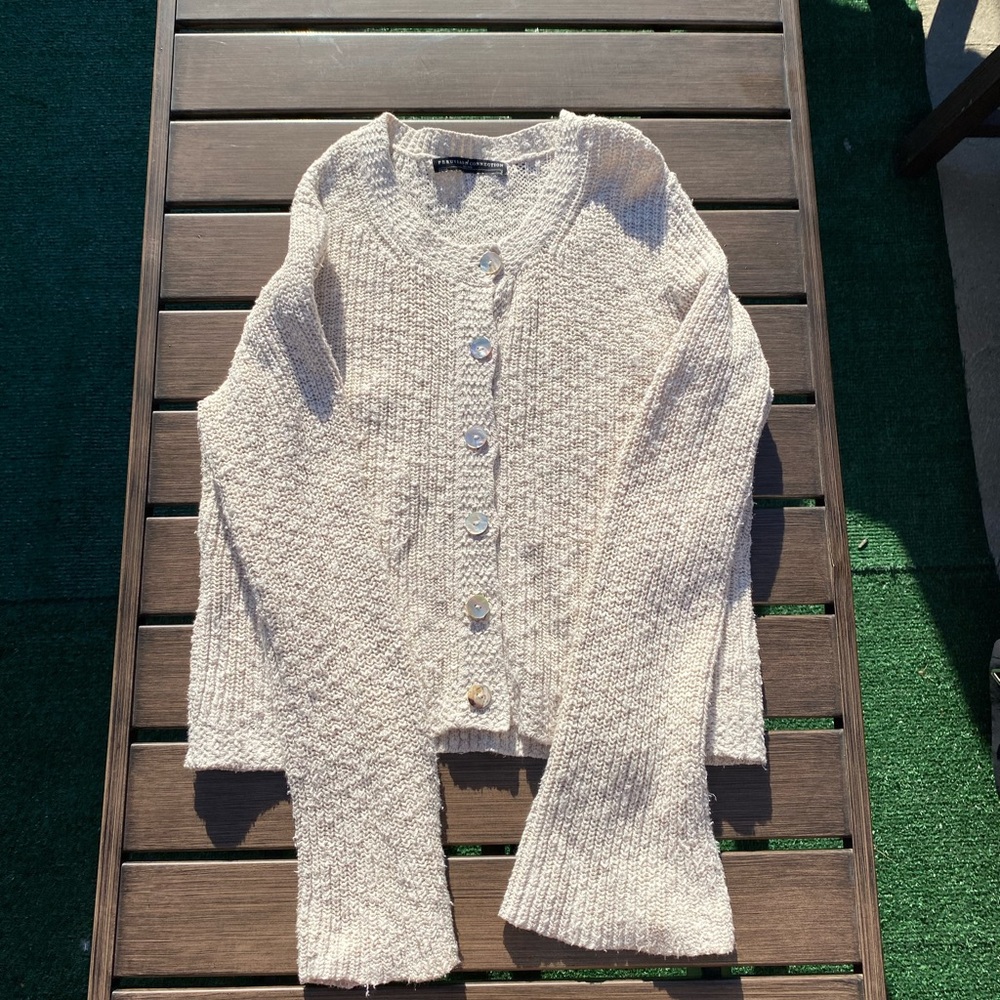 Knit cream flare sleeve sweater with iridescent buttons